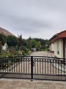 a black fence in front of a garden at Noclegi Dobrzeń Wielki in Dobrzeń Wielki