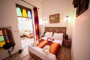 a bedroom with a large bed with shoes on it at Dar houda in Fès