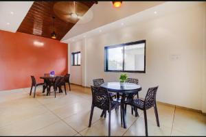 a dining room with a table and chairs at OCEAN CREST LUXURY VILLA Mahabaleshwar in Mahabaleshwar