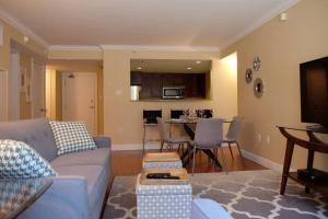 a living room with a couch and a dining room at Deluxe Downtown Apt #404 with AC in Halifax