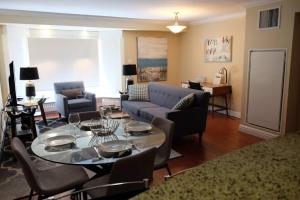 a living room with a table and a couch at Deluxe Downtown Apt #404 with AC in Halifax