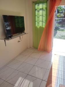 a living room with a television and a tiled floor at sunset lodge 