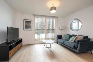 a living room with a couch and a tv at Monk Bridge Viaduct in Leeds