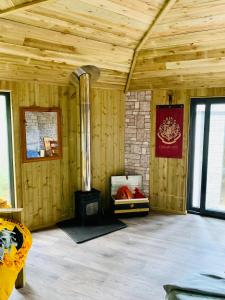 a wooden room with a woodburning stove in it at Hagrids Hut - Off grid Cabin - no electricity or running water in Munlochy