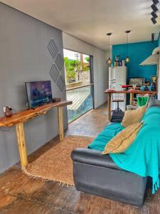 uma sala de estar com um sofá e uma mesa em C-house em Ubatuba