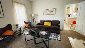 a living room with a couch and a table at Shotgun House in Silverton