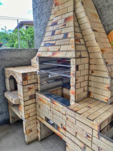 an outdoor pizza oven in a brick wall at C-house in Ubatuba +13 photos
