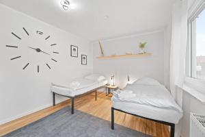 a bedroom with a bed and a clock on the wall at W01 Große Wohnung für Teams in Wendlingen am Neckar