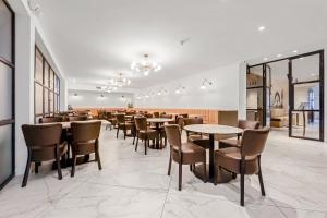 a restaurant with tables and chairs in a room at King Solomon Hotel- Golders Green in London