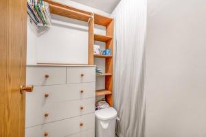 a bathroom with a toilet and a white dresser at The Lakeside Cabin with wide outside space #105 in West Kelowna +8 photos