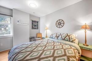 a bedroom with a bed and two lamps and a window at The Lakeside Cabin with wide outside space #105 in West Kelowna
