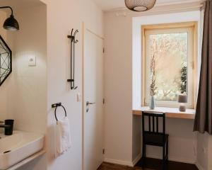 a bathroom with a sink and a window at Quinta da Quinhas in Vila Praia de Âncora +56 photos