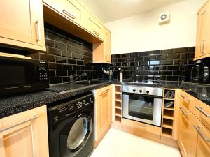 a kitchen with a washer and a dishwasher at Brunswick Court in Cowes