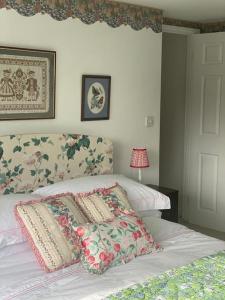 a bedroom with a bed with two pillows on it at Countryside cottage with private garden & hot tub in Lifton