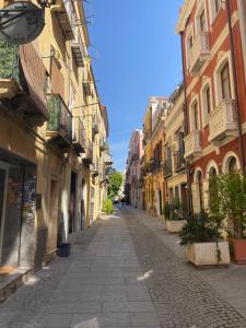 an empty street in a city with buildings at Guest House Villanova in Cagliari