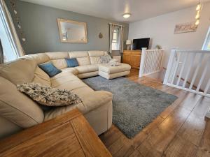a living room with a couch and a table at Bespoke coastal 2 bed cottage with free parking in Ilfracombe
