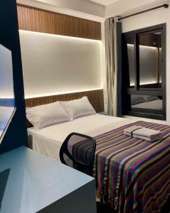 A bed or beds in a room at Flat Encantador Allianz Park 708