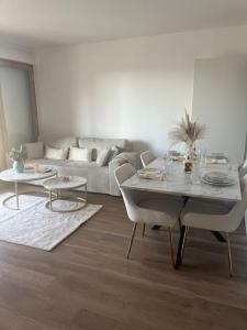 a living room with a table and a couch at Appartement luxueux Au coeur de lille in Lille