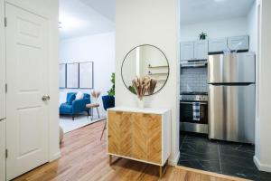 a kitchen with a mirror on a table and a refrigerator at 74-4A 2BR 2baths in Prime Upper West Side w d GYM in New York