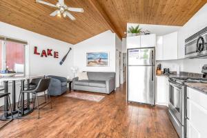 a kitchen and living room with a couch and a table at Beautiful Cabin Right next to Lake Okanagan #5 in West Kelowna +19 photos
