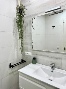 a bathroom with a white sink and a mirror at Casa Únic - Moderno Alojamiento en Ruzafa in Valencia