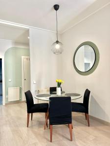 a dining room with a table and chairs and a mirror at Casa Únic - Moderno Alojamiento en Ruzafa in Valencia