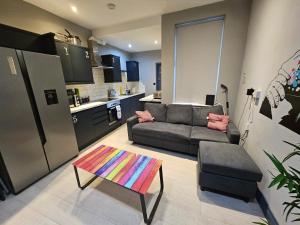 a living room with a couch and a table at Tudor Road House in Leicester