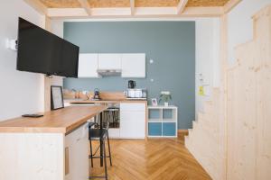 a kitchen with white cabinets and a counter top at Studio cosy avec mezzanine calme hypercentre Villa Marie Celine in Vichy