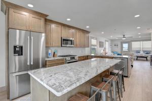 a kitchen with stainless steel appliances and a large counter top at Seaside Harbor Retreat in Mexico Beach