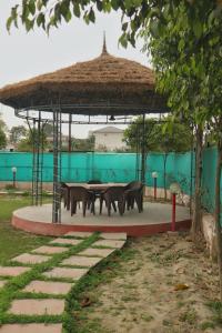 a group of animals standing around a table in a pavilion at NBR Resort in Noida