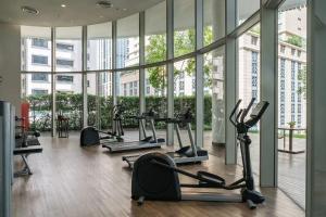 a gym with several tread machines in a building at Central Siam Chitlom Superb Luxury 80sqm in Bangkok
