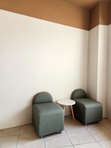two chairs and a table in a room at Baanmai Residence in Ban Krabi Yai +2 photos