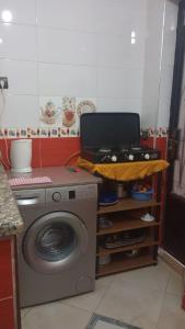 a kitchen with a laptop on top of a washing machine at Apartment 20m from Martil beach in Tetouan