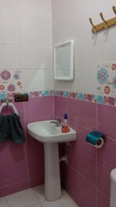 a bathroom with a sink and a mirror at Apartment 20m from Martil beach in Tétouan +17 photos