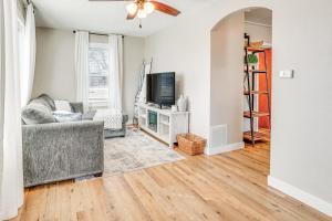 a living room with a couch and a tv at Pet-Friendly Watertown Home about 1 Mi to Downtown! in Watertown