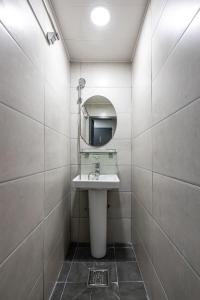 a bathroom with a sink and a mirror at K Stay 3rd Myeongdong City in Seoul