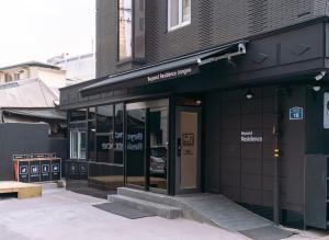 a store front of a building with a revolving door at K Stay 3rd Myeongdong City in Seoul