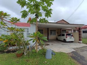 a house with a car parked in the driveway at JRC Homestay Kerteh in Kemaman