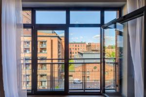 an open window with a view of a building at Lumina I Comfy Loft with Parking I View of the Lake in Łódź +22 photos