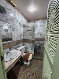 a bathroom with a toilet and a sink at Baanmai Residence in Ban Krabi Yai