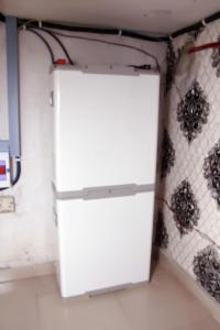 a white refrigerator in a room with spiders on the wall at Smilley's Place Roffi in Lagos