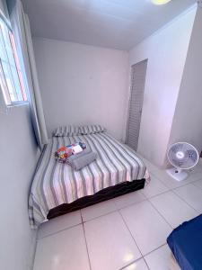 a bedroom with a bed in a room with a fan at Hostel e Pousada Jacumã in Conde