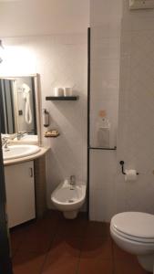 a bathroom with a toilet and a sink at LH Albergo Il Picchio in Pescasseroli