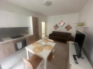 a living room with a white table and a couch at La villetta in Lido delle Nazioni