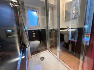 a bathroom with a shower and a toilet and a sink at Cefalù cozy flat in Cefalù