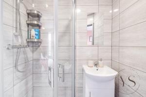 a white bathroom with a sink and a shower at Gorgeous Longton Studio 1d in Stoke on Trent