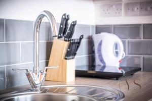 a kitchen counter with a sink and a mixer at Gorgeous Longton Studio 1a in Stoke on Trent