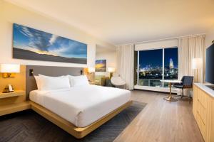 a hotel room with a bed and a large window at The Moran CITYCENTRE in Houston