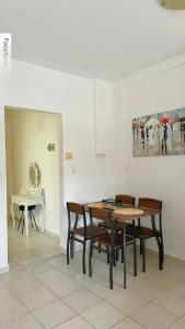 a dining room with a table and chairs at Elena Rooms-Apartments -B in Asprovalta