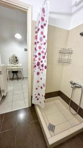 a bathroom with a shower with a shower curtain at Elena Rooms-Apartments -B in Asprovalta